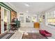 Bright sunroom with tiled floors, multiple windows, and a desk area with a computer, perfect for relaxation or work at 113 Surrey Dr, Summerville, SC 29486