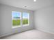 Bright bedroom with a scenic view from double hung windows and plush carpeting at 114 Orchard Blossom Ln, Summerville, SC 29485
