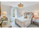 Comfortable bedroom with a large window, a decorative light fixture and soft lighting at 114 Orchard Blossom Ln, Summerville, SC 29485