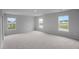 Large bedroom with plush carpeting and lots of natural light from the three windows at 114 Orchard Blossom Ln, Summerville, SC 29485
