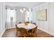 Cozy dining area featuring wainscoting, a modern chandelier, and a round table for intimate gatherings at 114 Orchard Blossom Ln, Summerville, SC 29485