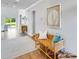 Bright entryway with a woven bench, stylish decor, wood flooring, and a view to the home's backyard at 114 Orchard Blossom Ln, Summerville, SC 29485