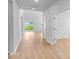 Hallway with wood flooring leading to a sliding glass door and an office with a glass paneled door at 114 Orchard Blossom Ln, Summerville, SC 29485