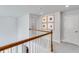 Hallway with wooden handrail, carpeted floor, and framed pictures on the wall at 114 Orchard Blossom Ln, Summerville, SC 29485