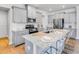 Well-lit kitchen featuring gray cabinets, stainless steel appliances, and a granite countertop island with seating at 114 Orchard Blossom Ln, Summerville, SC 29485