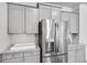 Kitchen area featuring gray cabinets, stainless steel refrigerator, and white subway tile backsplash at 114 Orchard Blossom Ln, Summerville, SC 29485