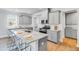 Well-lit kitchen featuring gray cabinets, stainless steel appliances, and a granite countertop island with seating at 114 Orchard Blossom Ln, Summerville, SC 29485
