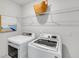 Bright laundry room with new washer and dryer with wire shelving at 114 Orchard Blossom Ln, Summerville, SC 29485