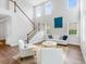 Open living space boasts tall ceilings, large windows, and access to the staircase with an open floorplan at 114 Orchard Blossom Ln, Summerville, SC 29485