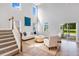 Airy living room with soaring ceilings, large windows, and an open floor plan with staircase access at 114 Orchard Blossom Ln, Summerville, SC 29485