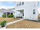 Charming backyard with a covered porch area, lush greenery, and a manicured lawn at 115 Winding Branch Dr, Summerville, SC 29486