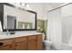Well-lit bathroom features a stylish vanity, a modern mirror, and a shower with a neutral-colored shower curtain at 115 Winding Branch Dr, Summerville, SC 29486