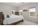 Bright bedroom with multiple windows and modern furnishings, including a wooden dresser and a queen bed at 115 Winding Branch Dr, Summerville, SC 29486