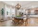Open concept dining area with modern light fixture, hardwood floors, and access to kitchen at 115 Winding Branch Dr, Summerville, SC 29486