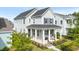 Charming two-story home with a welcoming front porch and beautifully landscaped yard at 115 Winding Branch Dr, Summerville, SC 29486