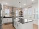 Modern kitchen features a brick accent wall, white cabinetry, and a large center island at 115 Winding Branch Dr, Summerville, SC 29486
