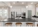 Open kitchen with modern appliances, center island with seating, and stylish pendant lighting at 115 Winding Branch Dr, Summerville, SC 29486