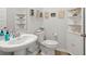 Charming half bathroom featuring seashell art and neutral coastal decor at 1150 Cooper Point St, Summerville, SC 29485
