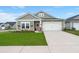 Charming single-story home with a well-manicured lawn, covered entrance, and attached two-car garage at 1150 Cooper Point St, Summerville, SC 29485