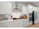 Bright kitchen features stainless hood, double oven, gas cooktop and white subway tile backsplash at 1150 Cooper Point St, Summerville, SC 29485