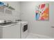 Laundry room featuring modern washer and dryer and shelving for supplies at 1150 Cooper Point St, Summerville, SC 29485