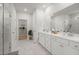 Modern main bathroom featuring marble floors, double vanity, a glass shower, and a large walk-in closet at 1150 Cooper Point St, Summerville, SC 29485