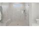 Modern marble shower showcasing a built-in bench, clear glass door, and natural light from the window at 1150 Cooper Point St, Summerville, SC 29485