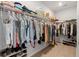 Walk-in closet with metal racks and hardwood floors for ample storage of clothing and shoes at 1150 Cooper Point St, Summerville, SC 29485