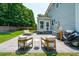 Inviting backyard with stone patio, outdoor seating, a basketball hoop, and lush landscaping at 1164 Sharpestowne Ct, Mount Pleasant, SC 29466