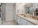 Modern bathroom featuring dual vanities, granite countertops, walk-in shower, and neutral tile flooring at 1164 Sharpestowne Ct, Mount Pleasant, SC 29466
