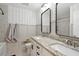 Updated bathroom featuring a granite double vanity, modern fixtures, and stylish wall decor at 1164 Sharpestowne Ct, Mount Pleasant, SC 29466