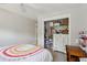 Well-lit bedroom featuring a closet, a comfortable bed with a colorful blanket, and a wooden desk at 1164 Sharpestowne Ct, Mount Pleasant, SC 29466