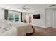 Primary bedroom boasts natural light, ceiling fan, and en suite bathroom access via sliding barn door at 1164 Sharpestowne Ct, Mount Pleasant, SC 29466