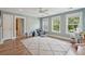 Spacious bedroom features three windows with backyard views, ceiling fan, and playroom accessories at 1164 Sharpestowne Ct, Mount Pleasant, SC 29466