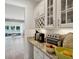 Butler's pantry with granite countertop, white cabinets, glass door accents, and stainless steel appliances at 1164 Sharpestowne Ct, Mount Pleasant, SC 29466
