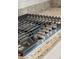 Stainless steel cooktop on granite countertop with white cabinets and subway tile backsplash at 1164 Sharpestowne Ct, Mount Pleasant, SC 29466