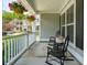 Inviting front porch with hanging flower baskets and comfortable rocking chairs at 1164 Sharpestowne Ct, Mount Pleasant, SC 29466