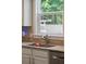 Bright kitchen featuring granite countertops, stainless steel faucet, and a window overlooking outdoor greenery at 1164 Sharpestowne Ct, Mount Pleasant, SC 29466