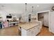 Open kitchen with granite island, stainless appliances, and view of the adjacent living room at 1164 Sharpestowne Ct, Mount Pleasant, SC 29466