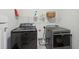Well-equipped laundry room with modern washer and dryer set and convenient shelving for storage at 1164 Sharpestowne Ct, Mount Pleasant, SC 29466