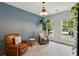 Comfortable living room with two leather chairs, side table, indoor plants, and plenty of natural light at 1164 Sharpestowne Ct, Mount Pleasant, SC 29466