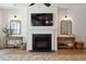 Bright living room featuring a fireplace, wooden accents, and decorative mirrors at 1164 Sharpestowne Ct, Mount Pleasant, SC 29466