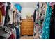 Organized walk-in closet with wooden dresser, hanging clothes, and shelving units for ample storage at 1164 Sharpestowne Ct, Mount Pleasant, SC 29466