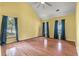 Bright bedroom features hardwood floors, high ceiling, and large windows with blue curtains at 117 Berringer Dr, Goose Creek, SC 29445