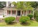 Charming two-story home with red shutters, landscaped front yard with a fenced in front porch at 117 Berringer Dr, Goose Creek, SC 29445