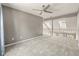 Open loft area with plush carpeting, ceiling fan, and views to the lower level with natural light from upper windows at 117 Berringer Dr, Goose Creek, SC 29445