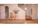 Welcoming entryway showcasing hardwood floors, a staircase, and a charming decorative chair at 1211 Meadow Park Ln # B, Mount Pleasant, SC 29464