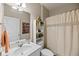 Neutral bathroom featuring a vanity, shelving, and a shower with a decorative curtain at 123 Lyra Ln, Summerville, SC 29486