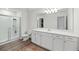 Modern bathroom with white cabinetry, dual vanity, glass enclosed shower, and stylish flooring at 123 Lyra Ln, Summerville, SC 29486