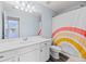 Charming bathroom featuring a rainbow shower curtain, white vanity, and modern fixtures at 123 Lyra Ln, Summerville, SC 29486